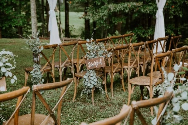 backyard wedding chair arrangement with a reserved sign