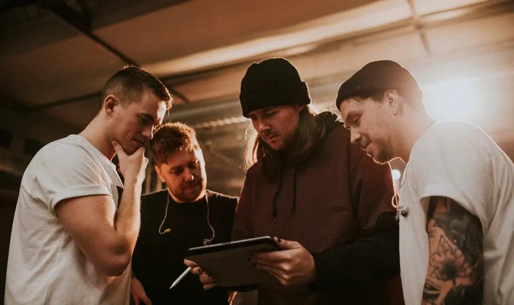 A band reviews contract information on an ipad before a performance.