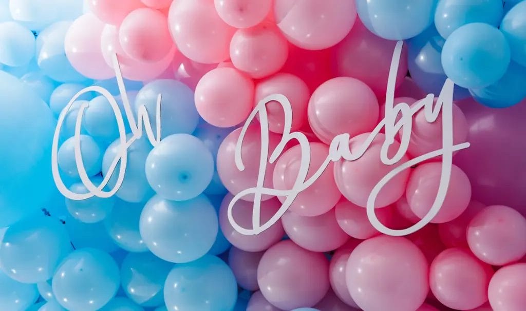 Pink and blue balloons for a gender reveal baby shower with the words "Oh Baby" over the top of them.