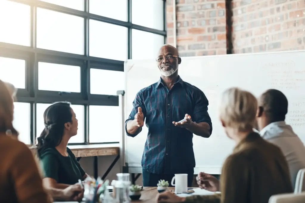 Senior business man doing presentation, planning and talking in a meeting,