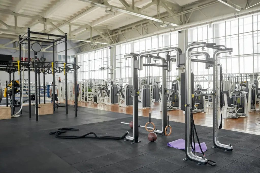 Interior of a large modern gym, with a rig in front and machines in the background.